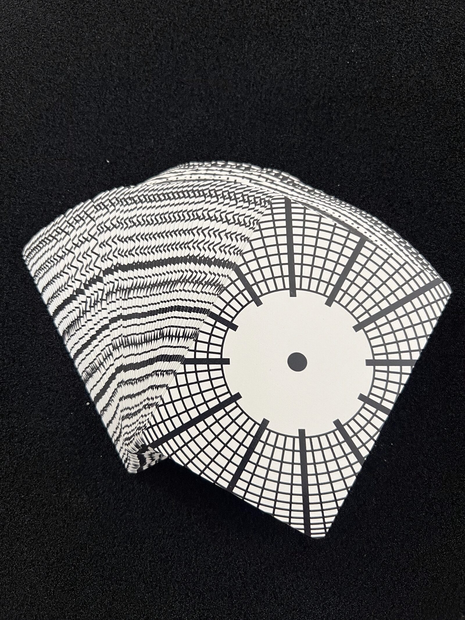 Fanned stack of Ikonology cards showing the clock-face card back design