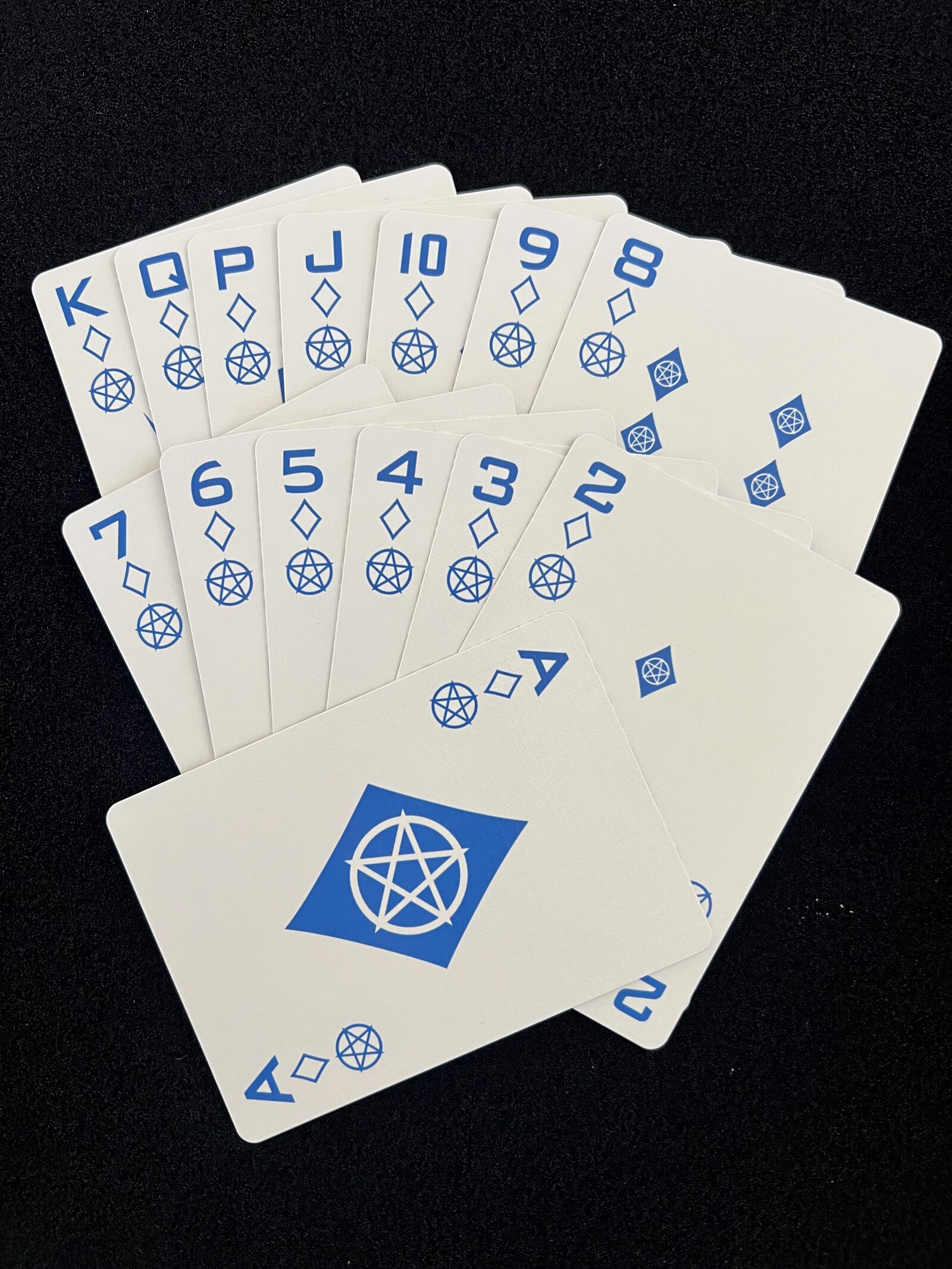 Fan of the Ikonology diamonds suit in blue, each card also marked with the tarot pentacles symbol