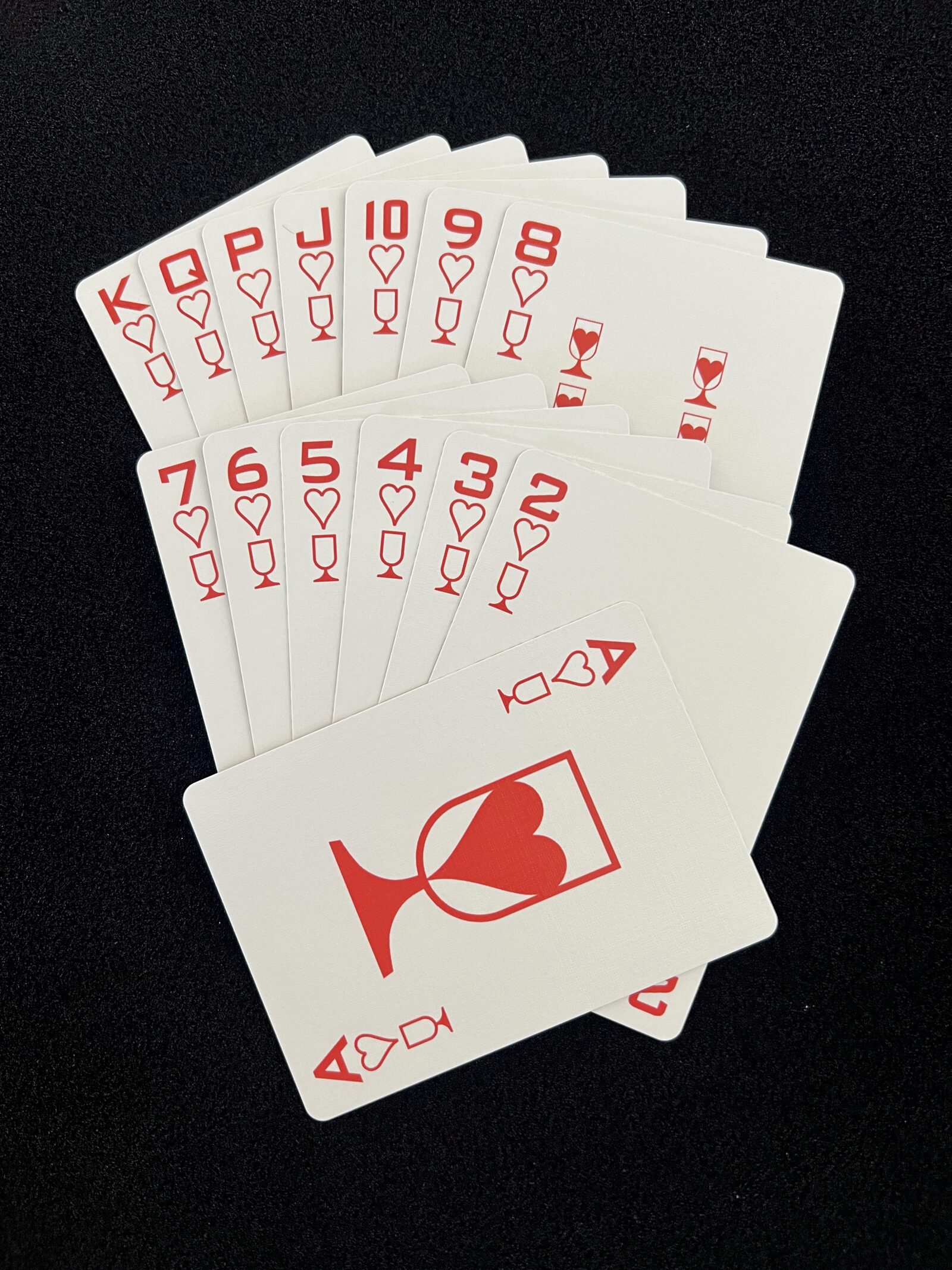 Fan of the Ikonology hearts suit in red, each card also marked with the tarot cups symbol
