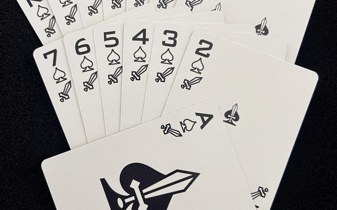 Fan of the Ikonology spades suit in black, each card also marked with the tarot swords symbol